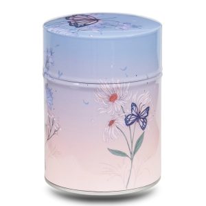 Metal tea caddy illustrated with a flower and butterflies on a pink and blue background.