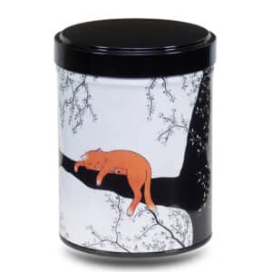 Artist's metal tea box illustrated with an orange cat napping in a black tree on a white background.